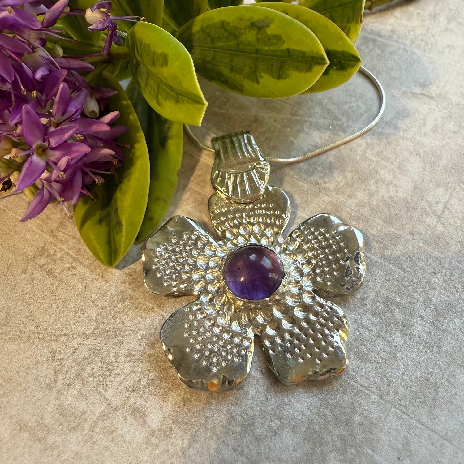 Textured flower pendant with amethyst stone